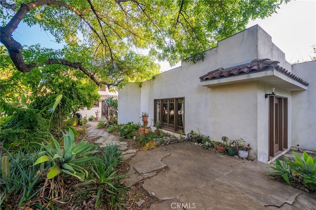 125 W 11th St, Claremont, CA 91711 - view of side of property with stucco siding and a patio