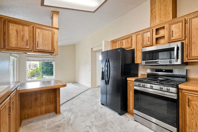 6496 Friendly Pl, Carlsbad, CA 92011 - kitchen with appliances with stainless steel finishes, light countertops, and brown cabinetry