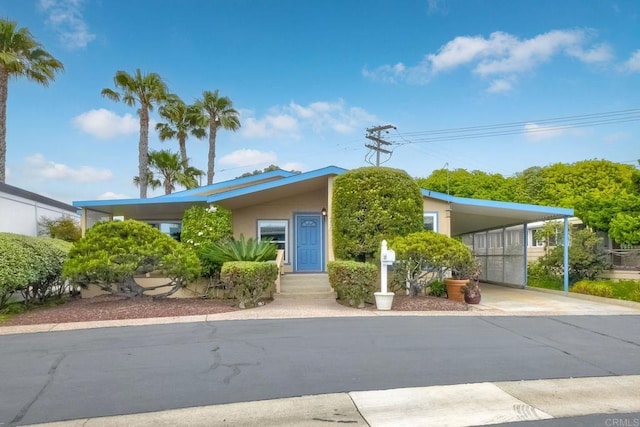 6496 Friendly Pl, Carlsbad, CA 92011 - view of front facade featuring a carport, stucco siding, and driveway