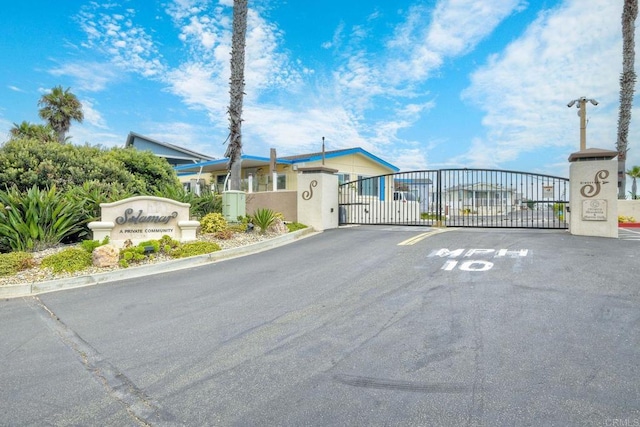 6496 Friendly Pl, Carlsbad, CA 92011 - view of asphalt road featuring a gate, a gated entry, and street lights
