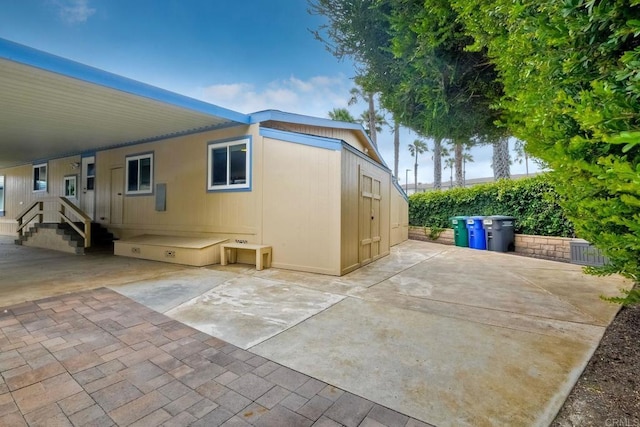 6496 Friendly Pl, Carlsbad, CA 92011 - view of side of property featuring a carport and a patio area