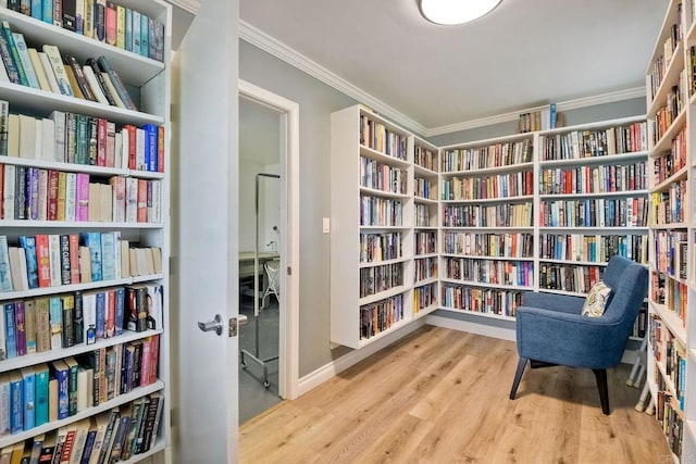 6496 Friendly Pl, Carlsbad, CA 92011 - sitting room with wall of books, crown molding, and wood finished floors