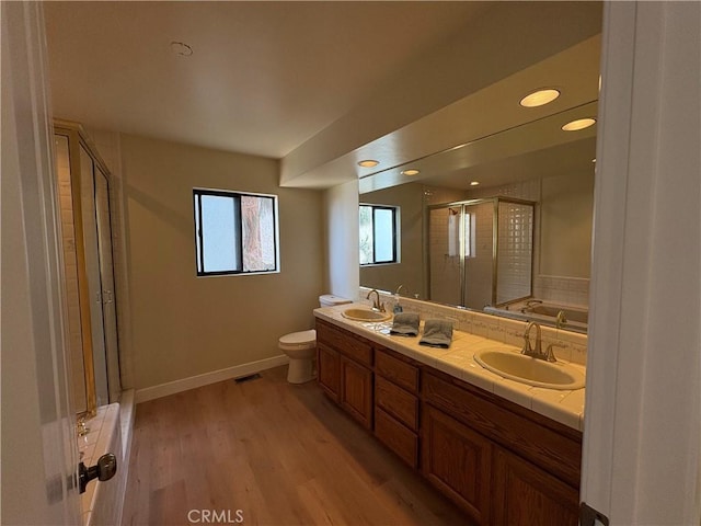 12070 Rideout Way, Whittier, CA 90601 - full bath featuring a stall shower, double vanity, toilet, a garden tub, and wood finished floors