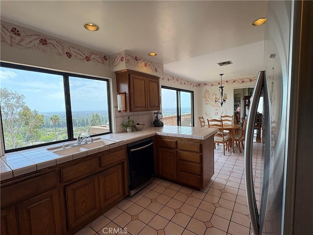 12070 Rideout Way, Whittier, CA 90601 - kitchen featuring dishwasher, tile counters, a peninsula, a sink, and brown cabinetry