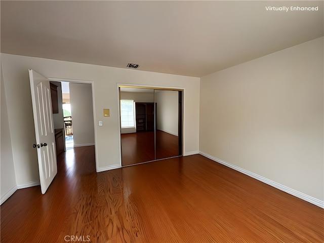 12070 Rideout Way, Whittier, CA 90601 - unfurnished bedroom featuring dark wood-type flooring, baseboards, and a closet
