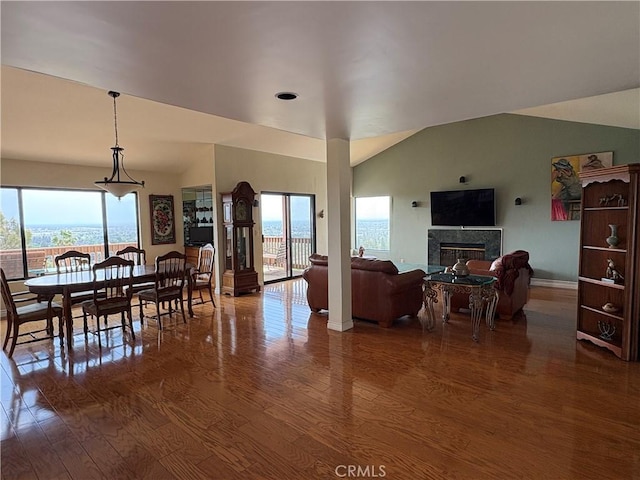 12070 Rideout Way, Whittier, CA 90601 - dining room featuring wood finished floors, healthy amount of natural light, a fireplace, baseboards, and lofted ceiling