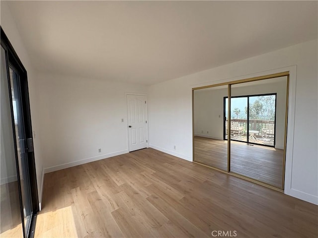 12070 Rideout Way, Whittier, CA 90601 - unfurnished bedroom with light wood-style flooring, access to outside, and baseboards