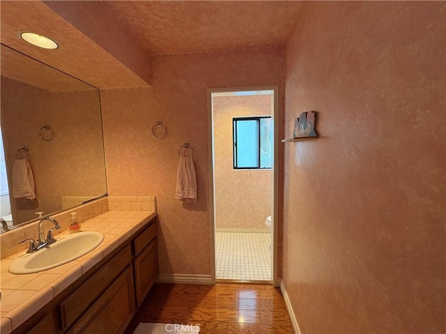 12070 Rideout Way, Whittier, CA 90601 - bathroom featuring vanity, baseboards, and toilet