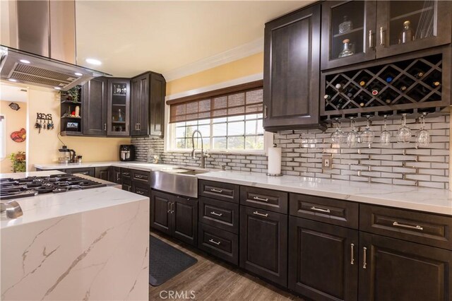 724 Forestview Ave, La Puente, CA 91746 - kitchen featuring a sink, island range hood, gas cooktop, decorative backsplash, and light stone counters