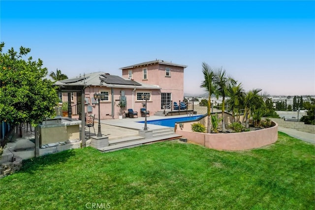 724 Forestview Ave, La Puente, CA 91746 - rear view of property with roof mounted solar panels, stucco siding, and a patio