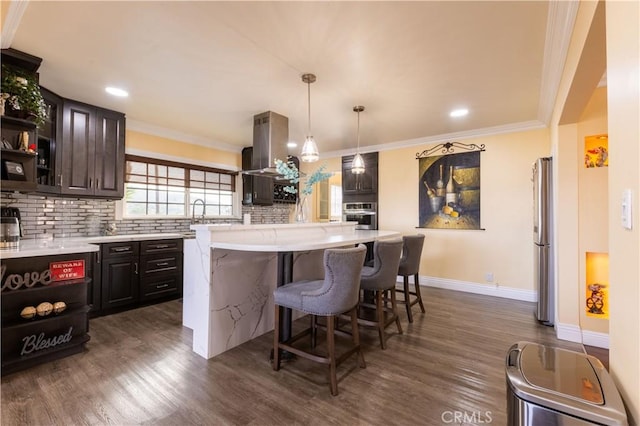 724 Forestview Ave, La Puente, CA 91746 - kitchen featuring appliances with stainless steel finishes, light countertops, a kitchen breakfast bar, tasteful backsplash, and crown molding