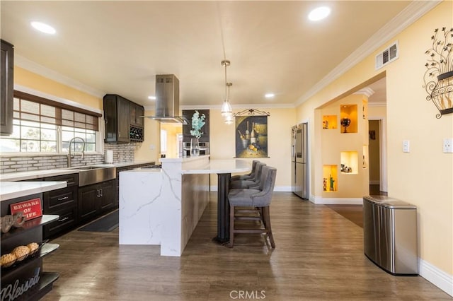 724 Forestview Ave, La Puente, CA 91746 - kitchen featuring island range hood, a center island, dark wood finished floors, a breakfast bar area, and baseboards