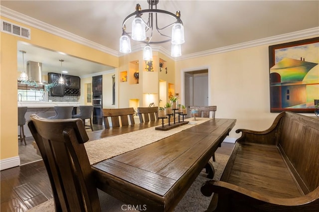 724 Forestview Ave, La Puente, CA 91746 - dining area with crown molding, baseboards, a chandelier, and wood finished floors