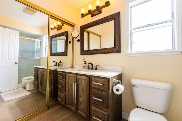 724 Forestview Ave, La Puente, CA 91746 - full bath with toilet, wood finished floors, double vanity, and an enclosed shower
