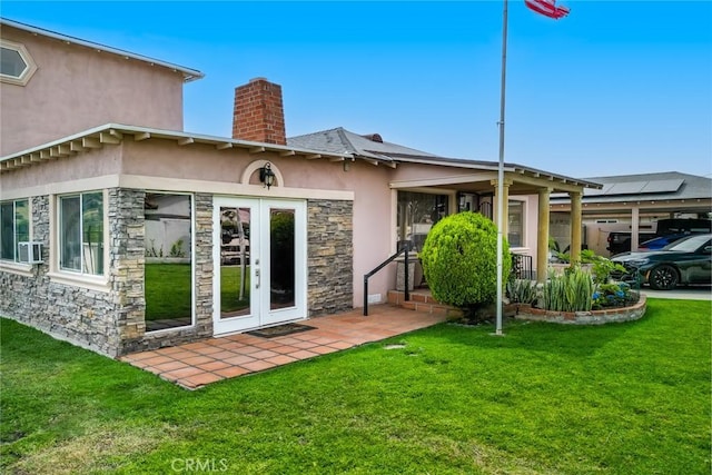 724 Forestview Ave, La Puente, CA 91746 - rear view of property featuring stone siding, stucco siding, a chimney, a yard, and french doors