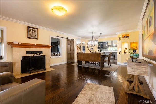 724 Forestview Ave, La Puente, CA 91746 - living room featuring a barn door, hardwood / wood-style flooring, crown molding, a fireplace with flush hearth, and baseboards