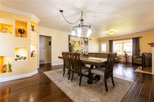 724 Forestview Ave, La Puente, CA 91746 - dining space with a chandelier, dark wood-style floors, and crown molding