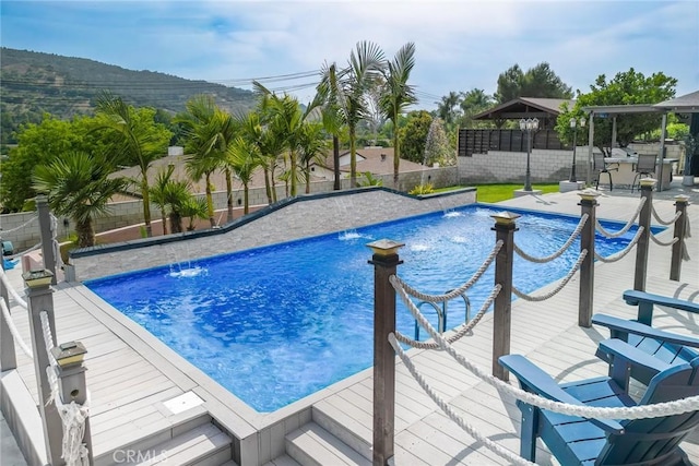 724 Forestview Ave, La Puente, CA 91746 - view of swimming pool featuring a fenced backyard and a deck with mountain view