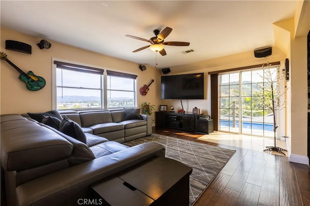 724 Forestview Ave, La Puente, CA 91746 - living area with ceiling fan, healthy amount of natural light, and dark wood-type flooring