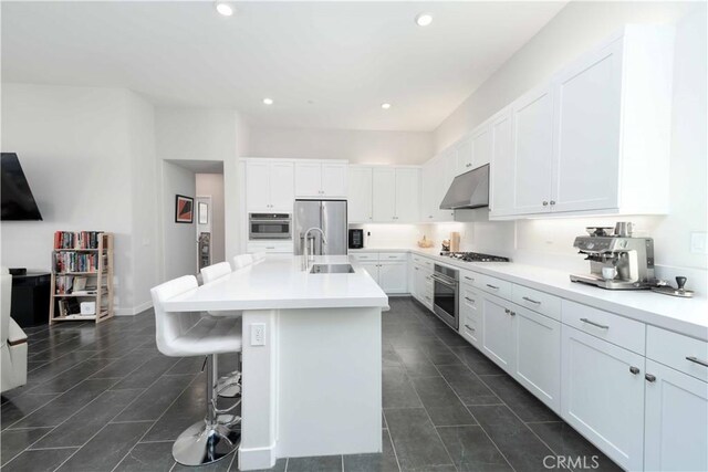 26956 Nature View Pl, Valencia, CA 91355 - kitchen with a sink, stainless steel appliances, dark tile patterned floors, white cabinetry, and recessed lighting