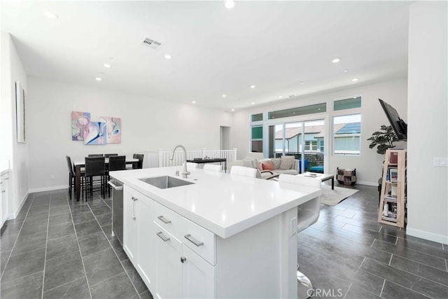 26956 Nature View Pl, Valencia, CA 91355 - kitchen with a sink, a breakfast bar area, recessed lighting, white cabinets, and a center island with sink