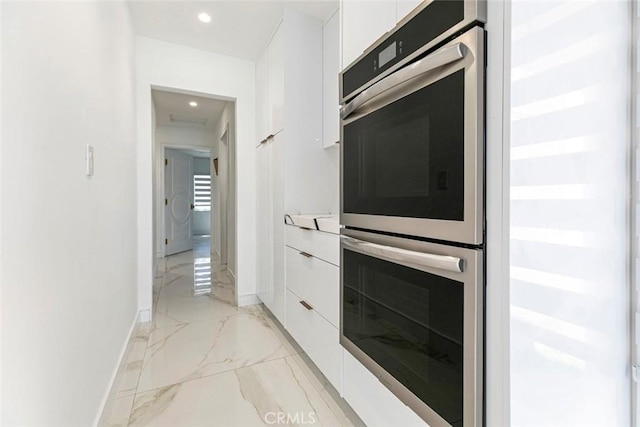 12410 Mclennan Ave, Granada Hills, CA 91344 - kitchen with double oven, modern cabinets, white cabinets, light marble finish floors, and light countertops