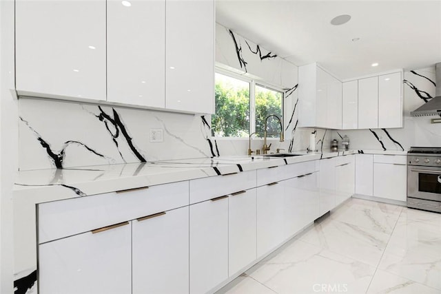 12410 Mclennan Ave, Granada Hills, CA 91344 - kitchen with modern cabinets, stainless steel stove, white cabinetry, light marble finish floors, and light countertops