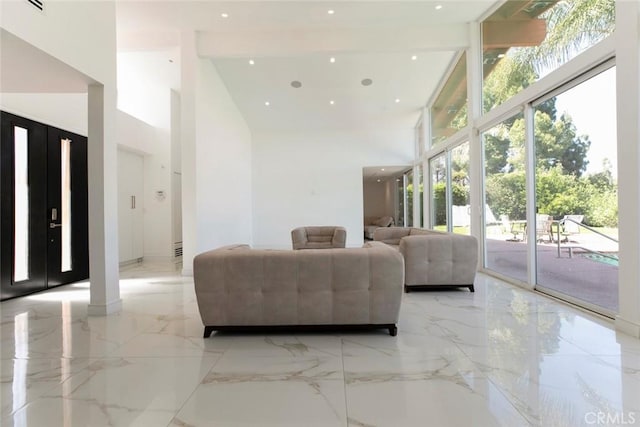 12410 Mclennan Ave, Granada Hills, CA 91344 - living area with high vaulted ceiling, light marble finish floors, healthy amount of natural light, and recessed lighting