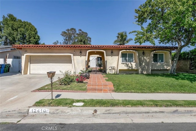 12410 Mclennan Ave, Granada Hills, CA 91344 - mediterranean / spanish home featuring stucco siding, an attached garage, and driveway