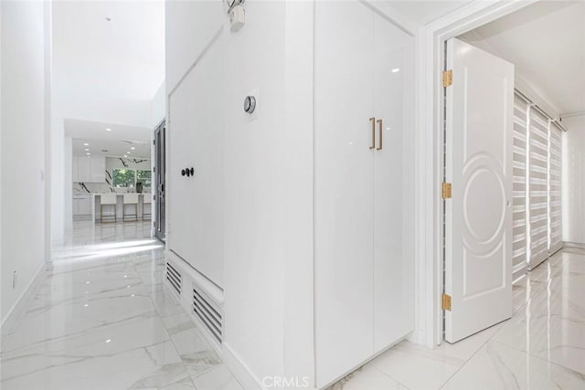 12410 Mclennan Ave, Granada Hills, CA 91344 - hall featuring light marble finish flooring and baseboards