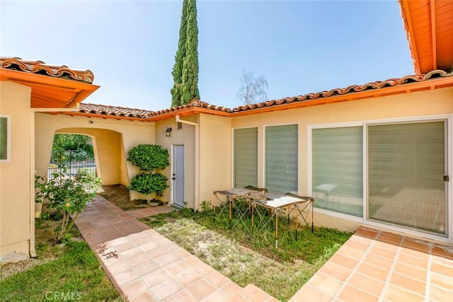12410 Mclennan Ave, Granada Hills, CA 91344 - view of exterior entry featuring a tile roof and stucco siding