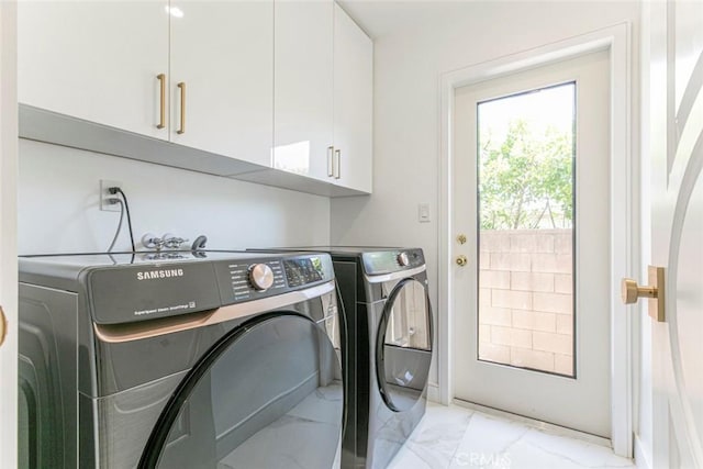 12410 Mclennan Ave, Granada Hills, CA 91344 - laundry room with cabinet space, light marble finish flooring, and separate washer and dryer