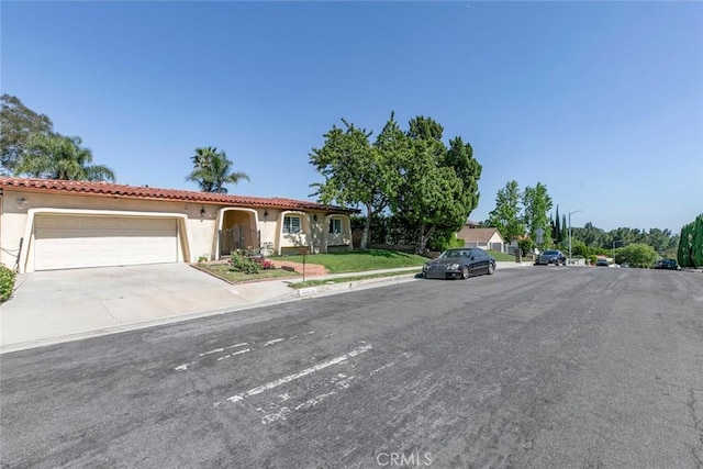 12410 Mclennan Ave, Granada Hills, CA 91344 - view of front of home with stucco siding, a tile roof, and an attached garage