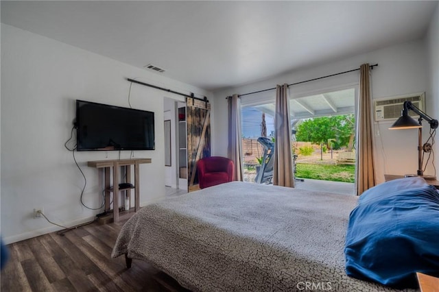 502 S Rosario Ave, San Jacinto, CA 92583 - bedroom with wood finished floors, a barn door, baseboards, access to exterior, and a wall mounted AC