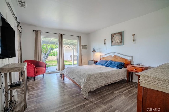 502 S Rosario Ave, San Jacinto, CA 92583 - bedroom featuring access to outside, dark wood-style floors, and a barn door