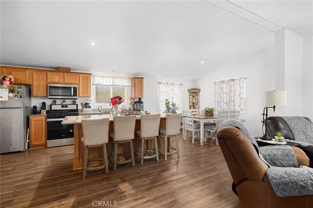 1863 Norwood Dr, Paradise, CA 95969 - kitchen with appliances with stainless steel finishes, open floor plan, dark wood-style flooring, a center island, and recessed lighting