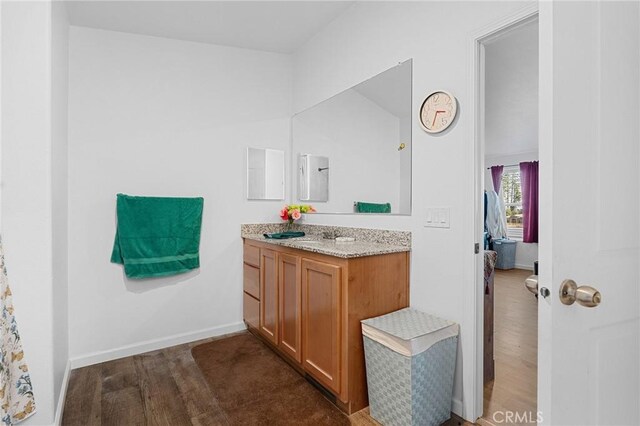 1863 Norwood Dr, Paradise, CA 95969 - bathroom featuring vanity, wood finished floors, baseboards, and ensuite bathroom