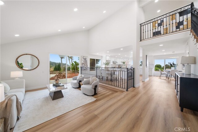 17585 Candela Dr, Rowland Heights, CA 91748 - living room featuring baseboards, high vaulted ceiling, light wood-type flooring, and recessed lighting