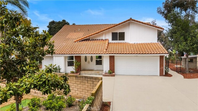 17585 Candela Dr, Rowland Heights, CA 91748 - mediterranean / spanish-style home with a tile roof, concrete driveway, and a garage