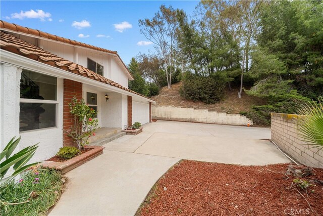 17585 Candela Dr, Rowland Heights, CA 91748 - view of patio featuring driveway and a garage