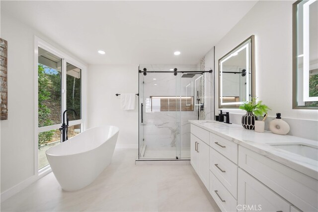 17585 Candela Dr, Rowland Heights, CA 91748 - full bath featuring a freestanding tub, a marble finish shower, double vanity, recessed lighting, and baseboards