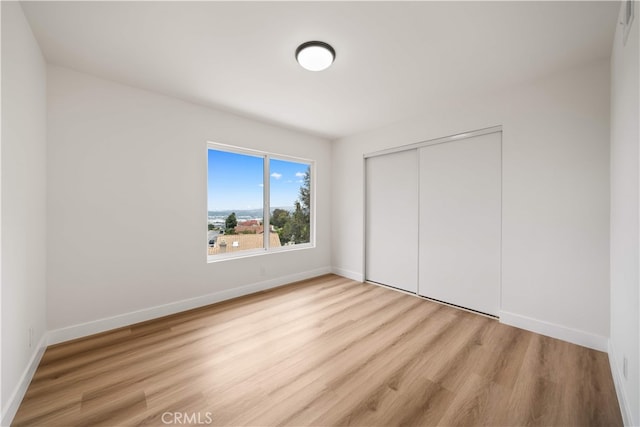 17585 Candela Dr, Rowland Heights, CA 91748 - unfurnished bedroom with wood finished floors, baseboards, and a closet