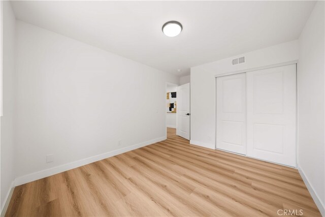 17585 Candela Dr, Rowland Heights, CA 91748 - unfurnished bedroom with light wood-type flooring, a closet, and baseboards