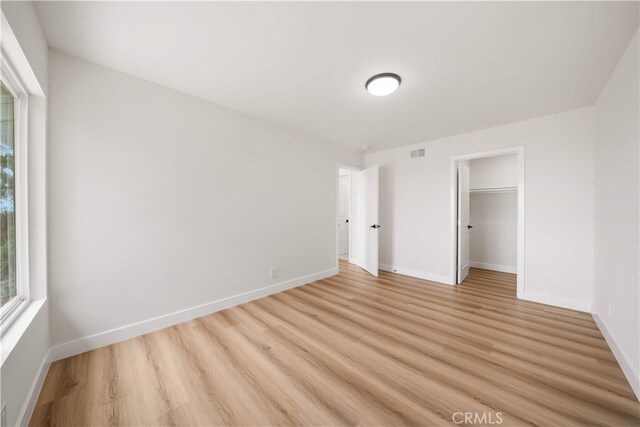 17585 Candela Dr, Rowland Heights, CA 91748 - unfurnished bedroom featuring light wood-style floors, baseboards, and a spacious closet