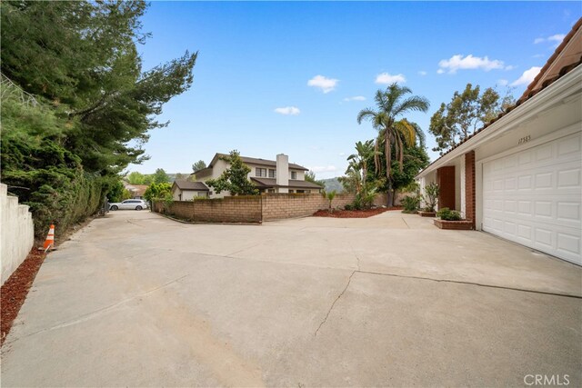 17585 Candela Dr, Rowland Heights, CA 91748 - view of patio with concrete driveway and a garage