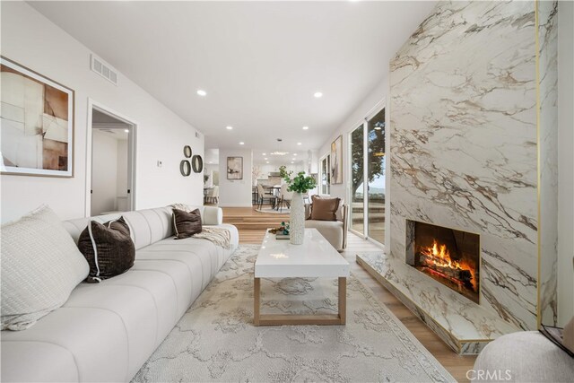 17585 Candela Dr, Rowland Heights, CA 91748 - living room with light wood-type flooring, a fireplace, and recessed lighting