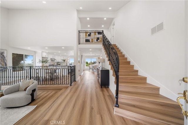 17585 Candela Dr, Rowland Heights, CA 91748 - foyer entrance featuring a towering ceiling, healthy amount of natural light, recessed lighting, light wood finished floors, and stairs