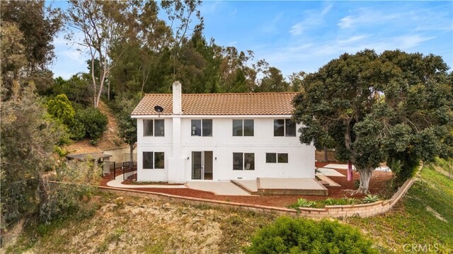 17585 Candela Dr, Rowland Heights, CA 91748 - back of property featuring a patio, a tiled roof, a chimney, and stucco siding