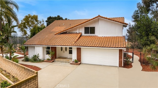 17585 Candela Dr, Rowland Heights, CA 91748 - mediterranean / spanish home with a tiled roof, concrete driveway, an attached garage, and covered porch
