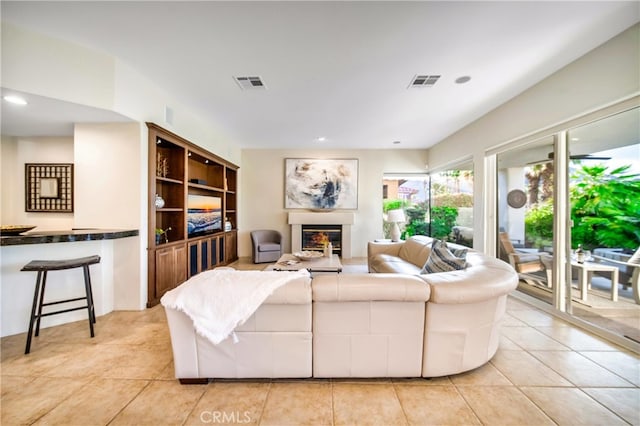 79980 Merion Ln, Quinta, CA 92253 - living room featuring a glass covered fireplace and light tile patterned flooring